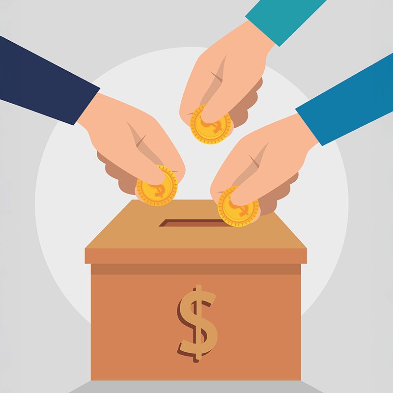 Three hands place gold-colored coins into a brown donation or savings box with a dollar sign ($) on the front. The box has a slot on top and is centered against a light gray background with a circular white area behind it. The image visually represents collective financial contribution, savings, or charitable giving
