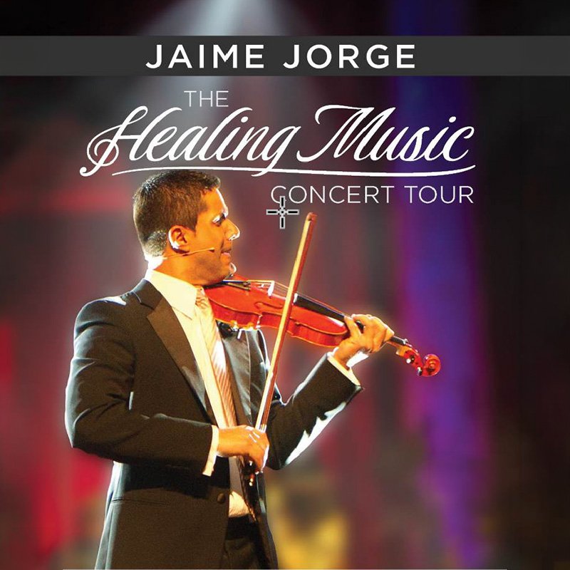 A promotional poster featuring violinist Jaime Jorge wearing a black suit, white shirt, and light-colored tie while playing a red violin. Warm, blurred stage lighting fills the background. Text on the poster reads “Jaime Jorge – The Healing Music Concert Tour.”